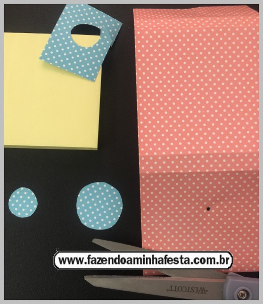 Dobre o papel ao redor do bloquinho, marcando bem as dobras, e recorte dois círculos em dois tamanhos.